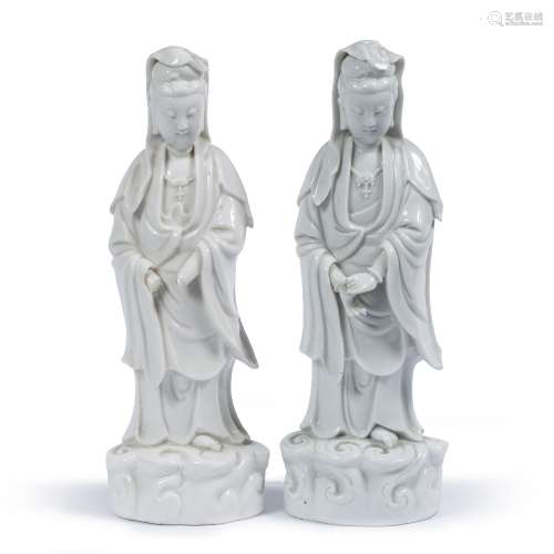 Two dehua porcelain figures of Guanyin Chinese both with flowing robes, standing on a raised rocky