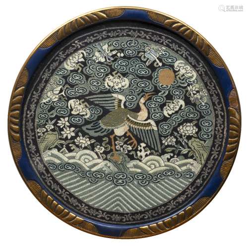 Circular fabric rank badge Chinese decorated with a stork to the centre in flight above a rough