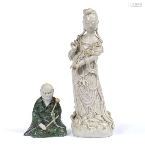 Dehua porcelain figure of Guanyin Chinese dressed in traditional robes adorned with jewellery, her