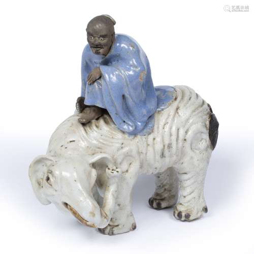 Shiwan porcelain figure Chinese, 19th century depicting a sage riding an elephant 24cm across