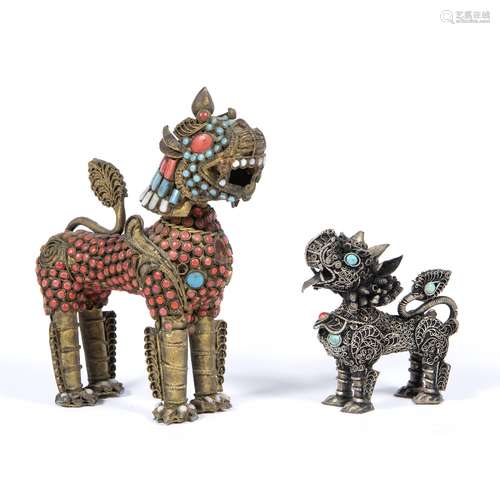 Two models of temple dogs Chinese the first decorated in silver filigree, the second cast in metal