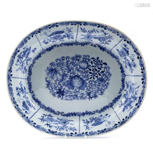 Oval blue and white dish Chinese, 18th Century decorated with a central panel depicting flowers, the