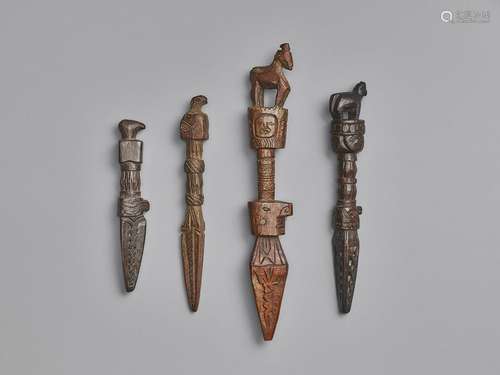 FOUR NEPALESE CARVED WOOD PHURBUS