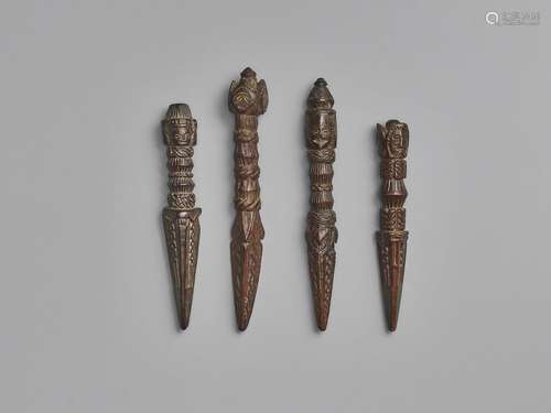 FOUR NEPALESE CARVED WOOD PHURBUS