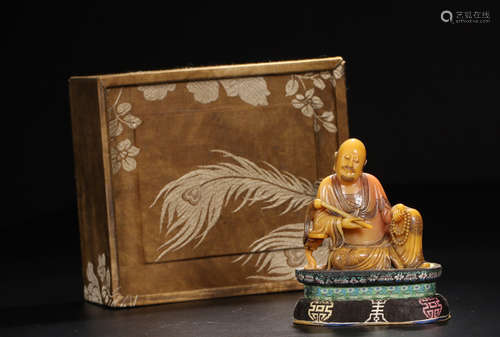 A SOAPSTONE CARVED HOLDING LUOHAN BUDDHA