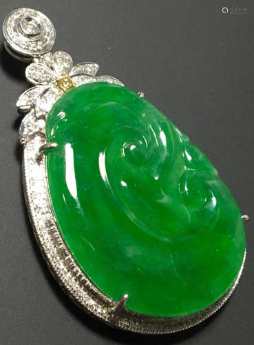 A GREEN JADEITE CARVED AUSPICIOUS PENDANT, TYPE A