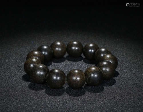 A CHENXIANG WOOD BRACELET MADE OF BEADS