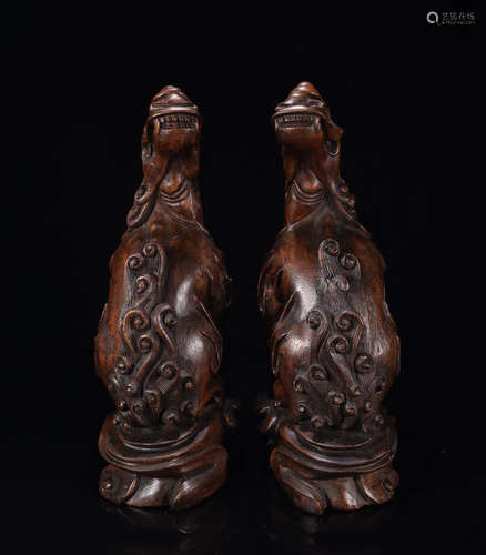 A PAIR OF CHENXIANG WOOD ORNAMENTS OF HOWLING