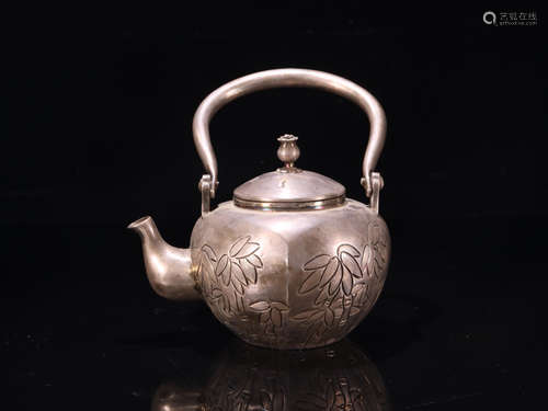 A SILVER TEAPOT WITH BAMBOO PATTERNS