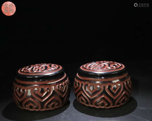 A PAIR OF RED LACQUERWOOD CHESS PIECE HOLDING JARS