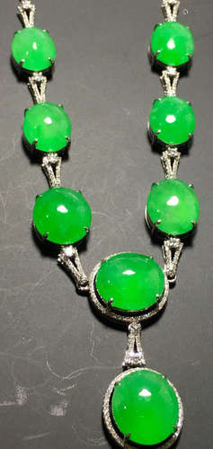 A GREEN JADEITE CARVED CIRCLE NECKLACE, TYPE A