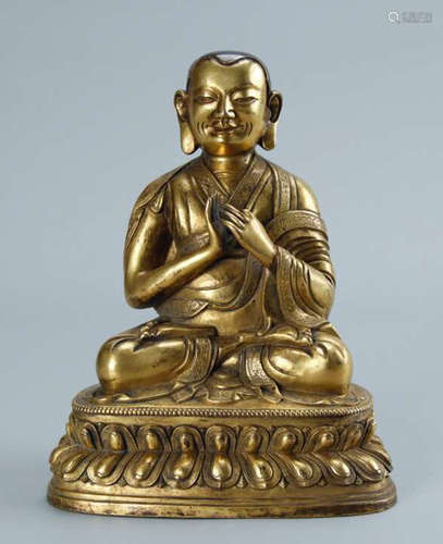 A GILT BRONZE GURU BUDDHA