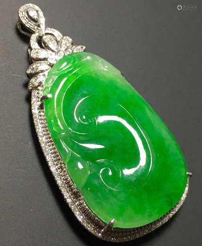 A GREEN JADEITE CARVED AUSPICIOUS PENDANT, TYPE A