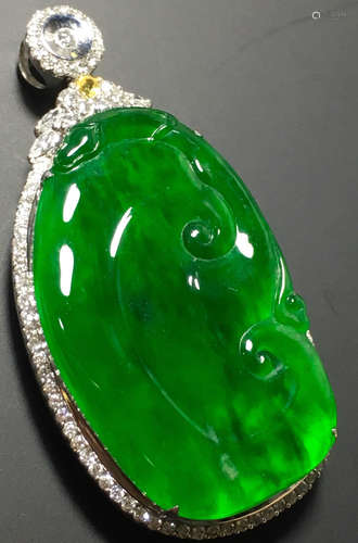 A GREEN JADEITE CARVED AUSPICIOUS PENDANT, TYPE A