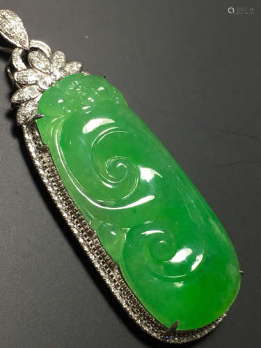 A GREEN JADEITE CARVED AUSPICIOUS PENDANT, TYPE A