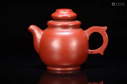 AN OLD RED PURPLE CLAY TEAPOT