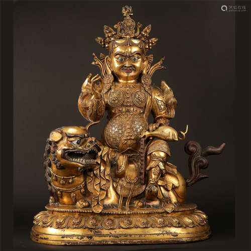 LARGE TIBETAN GILT BRONZE SEATED YELLOW JAMBHALA ON LION