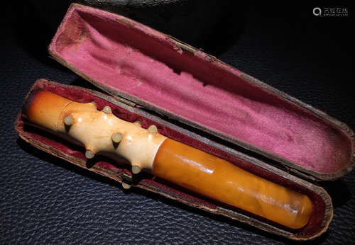 AN OLD BEESWAX CARVED TOBACCO ROD