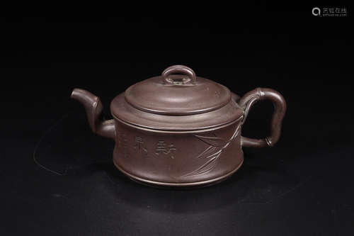 A ZISHA TEAPOT WITH CARVING