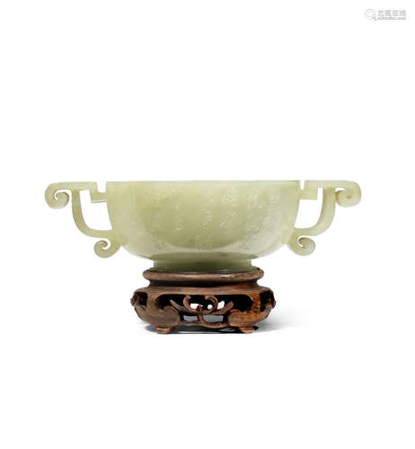 A CHINESE TWO HANDLED PALE CELADON JADE CUP QING D...;