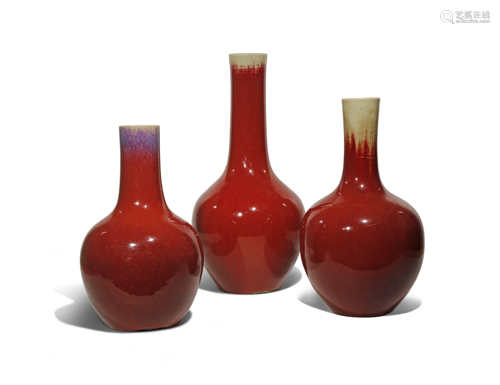 THREE LARGE CHINESE FLAMBE GLAZED BOTTLE VASES 19TH CENTURY Each with an ovoid body rising to a tall