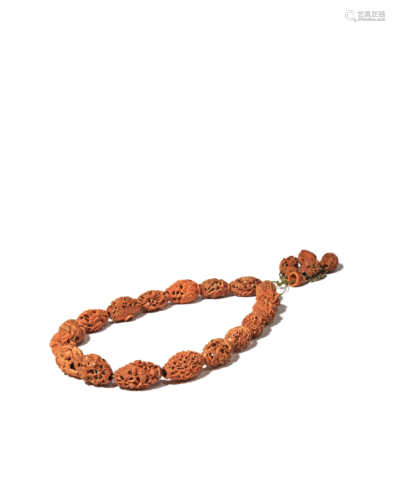 A CHINESE OLIVE STONE NECKLACE 19TH CENTURY The necklace composed of eighteen beads, with a