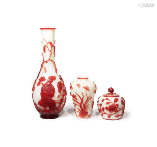 TWO CHINESE RED-OVERLAY GLASS VASES AND ONE JAR AND COVER LATE QING DYNASTY One a bottle vase carved