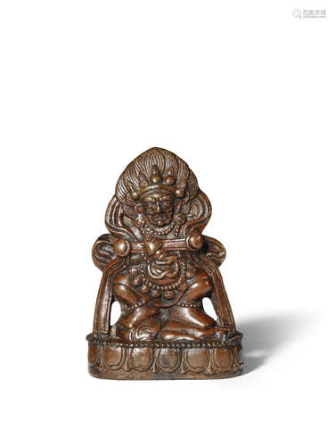 A TIBETO-CHINESE BRONZE FIGURE OF MAHAKALA MING DYNASTY OR LATER He stands upon a human corpse