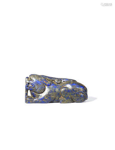 A CHINESE LAPIS LAZULI CARVING OF A LION DOG LATE QING DYNASTY In a recumbent pose, with its eyes