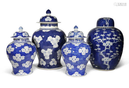 FOUR CHINESE BLUE AND WHITE 'PRUNUS' VASES AND COVERS 19TH CENTURY Three of the vases baluster-