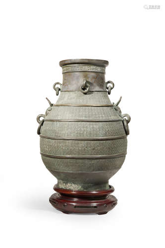 A CHINESE BRONZE ARCHAISTIC HU-SHAPED VASE QING DYNASTY The neck with four loose ring handles and