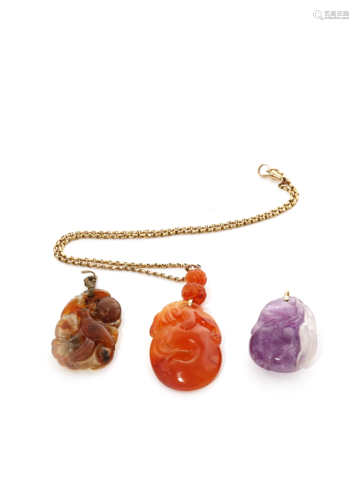 THREE CHINESE PENDANTS QING DYNASTY AND LATER Comprising: an amethyst pendant formed as two peaches,