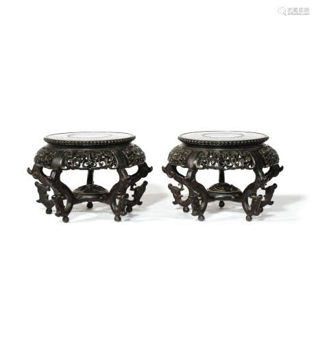 A PAIR OF CHINESE CIRCULAR WOOD STANDS 19TH CENTURY Carved in openwork with scrolling designs,