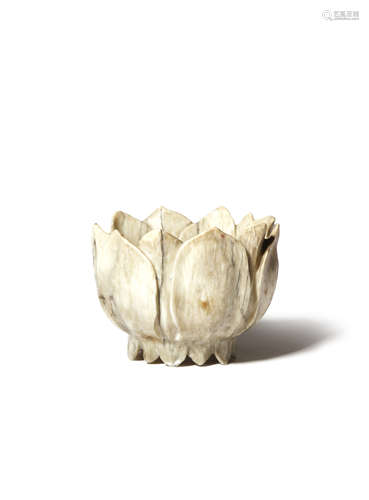 A CHINESE CHICKEN-BONE JADE 'LOTUS' CUP MING DYNASTY Formed as a single lotus flowerhead, the centre