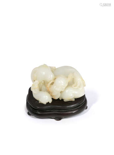 A CHINESE PALE CELADON JADE GROUP OF THREE RAMS QING DYNASTY OR LATER Carved as a large recumbent