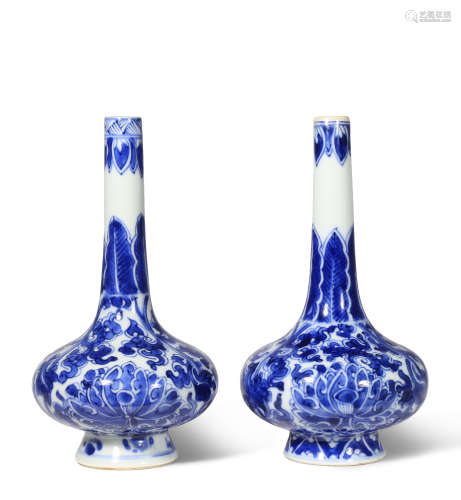 A NEAR PAIR OF CHINESE BLUE AND WHITE 'LOTUS' BOTTLE VASES KANGXI 1662-1722 Each with a compressed