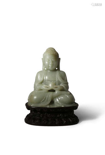 A CHINESE CELADON JADE SEATED BUDDHA QING DYNASTY OR LATER Carved with a meditative expression,