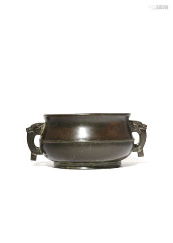 A CHINESE BRONZE INCENSE BURNER 17TH/18TH CENTURY The bomb?-shaped body cast with a raised