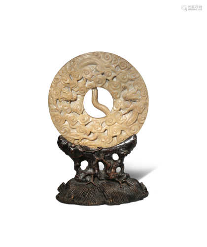 A CHINESE SOAPSTONE CIRCULAR 'DRAGON' BI DISC LATE QING DYNASTY Carved in relief with two sinuous