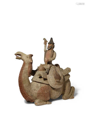 A CHINESE POTTERY MODEL OF A FIGURE RIDING A BACTRIAN CAMEL TANG DYNASTY The camel in a recumbent