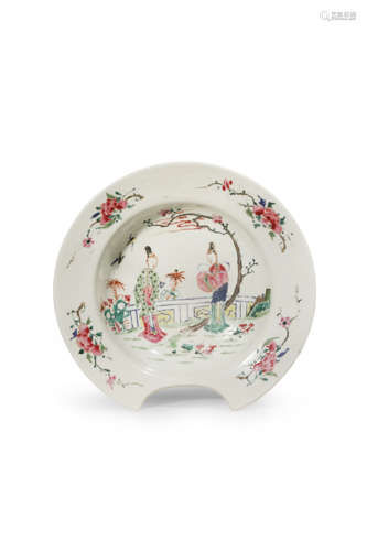 A CHINESE FAMILLE ROSE BARBER'S BOWL EARLY 18TH CENTURY Painted with two ladies in a fenced garden