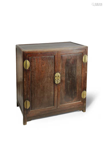A CHINESE TIELIMU CABINET 19TH CENTURY With a rectangular hongmu top, four brass hinges to the
