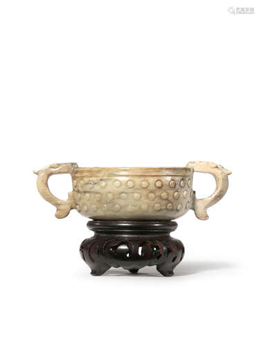 A CHINESE CHICKEN-BONE JADE TWO-HANDLED BOWL QING DYNASTY Carved in relief with a band of studs to