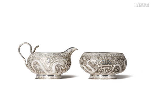 A SILVER CREAM JUG AND SUGAR BOWL, PROBABLY INDO-CHINESE 19TH CENTURY Decorated in repouss? with