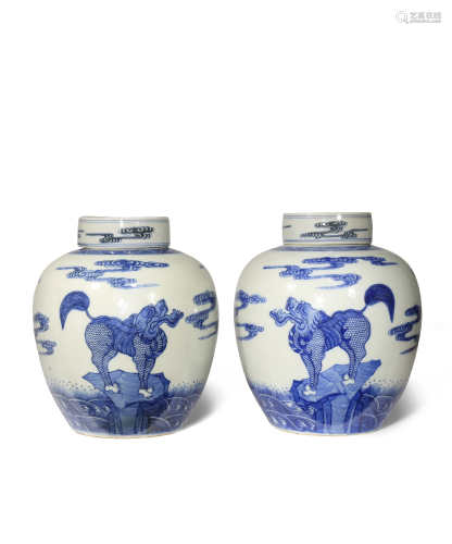 A PAIR OF CHINESE BLUE AND WHITE OVOID JARS AND COVERS C.1900 Each painted with mythical beasts