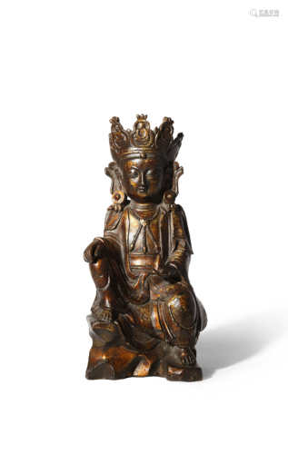 A CHINESE LACQUERED BRONZE FIGURE OF GUANYIN 17TH CENTURY Dressed in long robes, she sits on