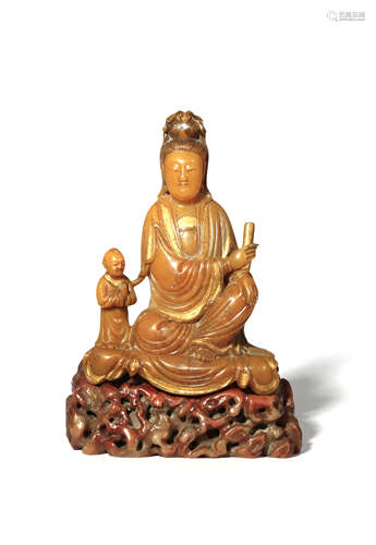 A CHINESE SOAPSTONE CARVING OF GUANYIN AND CHILD QING DYNASTY She sits in rajalilasana holding a