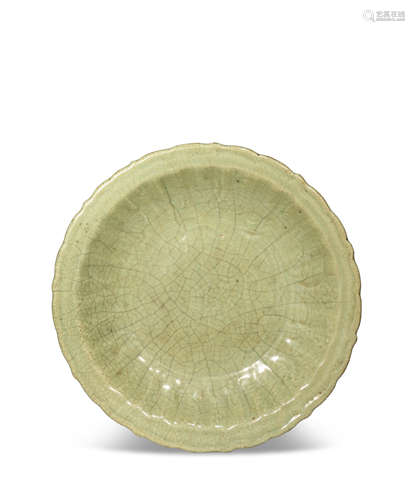 A LARGE CHINESE LONGQUAN CELADON DISH 14TH/15TH CENTURY The shallow body with an everted rim, the