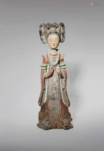 A CHINESE PAINTED POTTERY FIGURE OF A COURT LADY TANG DYNASTY She stands with her hands before her