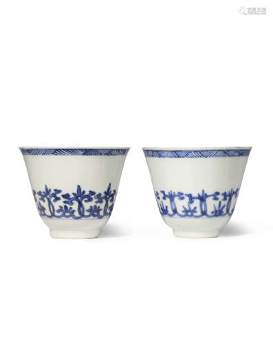 TWO CHINESE BLUE AND WHITE CUPS KANGXI 1662-1722 Each decorated with a band of stylised scrolling